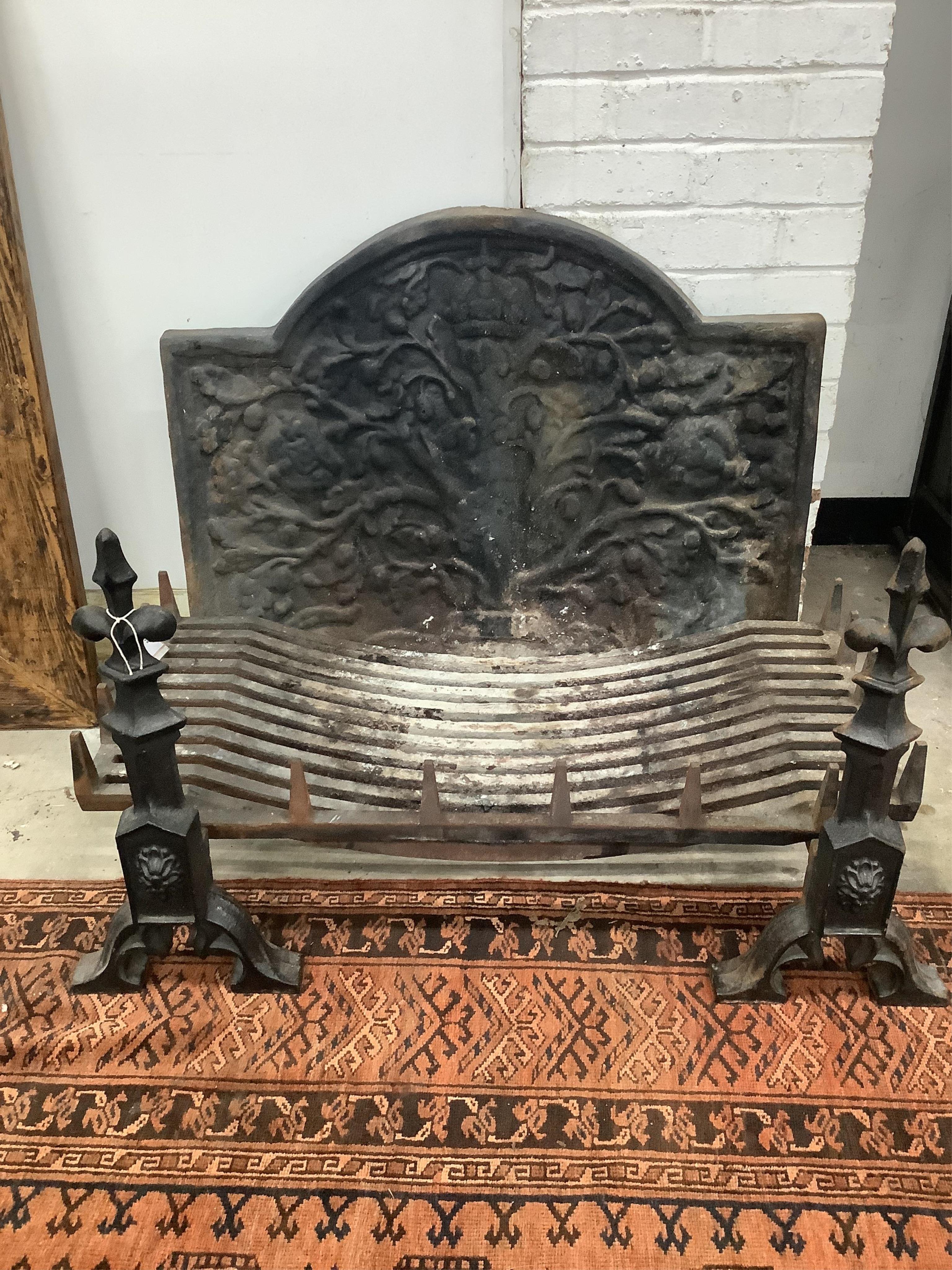 A cast iron fireback together with a fire grate, width 92cm, height 72cm and supporting fire dogs. Condition - fair